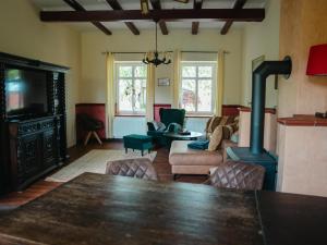 a living room with a wood stove and a couch at Faehrmann-s-Huus-Ditzum in Ditzum