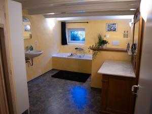 a bathroom with a tub and a sink and a bath tub at Faehrmann-s-Huus-Ditzum in Ditzum +58 photos