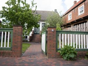 a fence with a gate in front of a house at Faehrmann-s-Huus-Ditzum in Ditzum