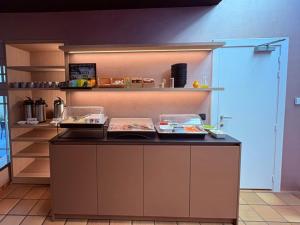 a kitchen with a counter with some food on it at Parkhotel Gent Centrum in Ghent