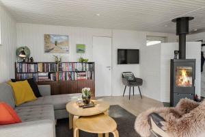 a living room with a couch and a fireplace at OH451-Hadsund-Haslevgaarde-Bakker-72 in Hadsund