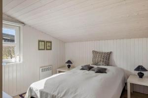 a bedroom with a white bed with two tables and a window at OH451-Hadsund-Haslevgaarde-Bakker-72 in Hadsund