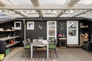 a patio with a table and chairs on a deck at OH451-Hadsund-Haslevgaarde-Bakker-72 in Hadsund