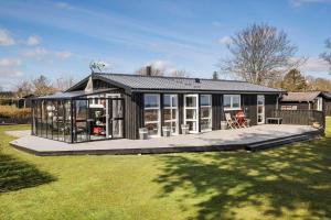 a large black house with a lot of windows at OH451-Hadsund-Haslevgaarde-Bakker-72 in Hadsund