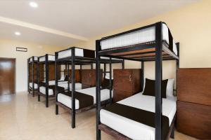 a group of bunk beds in a room at Collection O Langkawi Near Pantai Cenang formerly Tokman Inn in Pantai Cenang