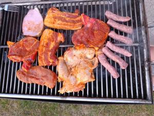 a bunch of meat and bacon on a grill at Vrba in Gacko