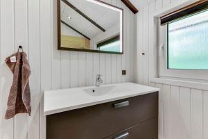 a bathroom with a sink and a mirror at BV383-Blavand-Toldbodvej-34 in Blåvand +35 photos