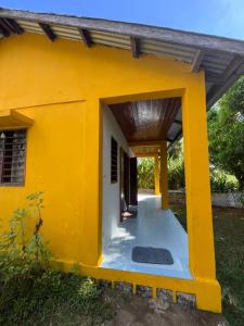 a yellow house with a entrance to it at La maison jaune in Nosy Be