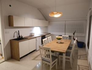 a kitchen with a wooden table and chairs at Mare Blue in Pirovac