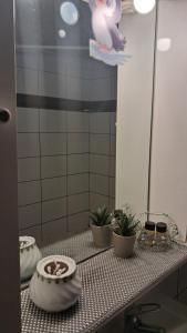 a bathroom counter with a mirror and plants on it at MARIOS HOUSE 1 in Xanthi