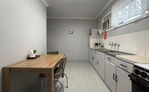 a kitchen with a wooden table in a kitchen at Kimba Units - Better than a motel room - self contained and pet friendly in Kimba