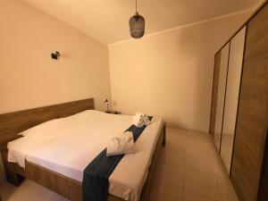 a bedroom with a bed with two bags on it at Salty Sun Seafront Penthouse in Marsalforn
