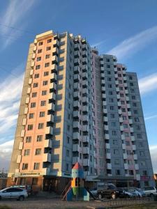 a large building with cars parked in front of it at 2 bed apartment in Buural