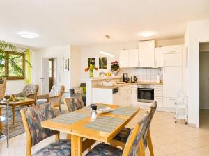 a kitchen and living room with a wooden table and chairs at Zur Kapellenwiese in Oberthal