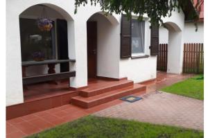 a front porch of a house with stairs and a door at Domki na Olszynki in Okuninka +4 photos
