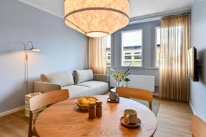 a living room with a table and a couch at The Break Hotel in Herning