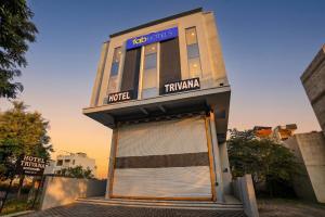 a building with a large garage door in front of it at FabHotel Trivana, Mahalaxmi Nagar in Indore