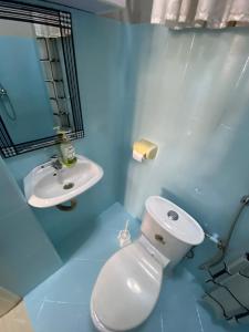 a bathroom with a white toilet and a sink at Kampala city center vin haven in Kampala +17 photos
