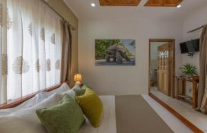 a living room with a couch and a painting on the wall at Maison Ed-Elle in La Digue