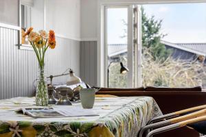 a table with a vase with flowers on it at SL343-Slagelse-Bygvangen-7 in Strandlyst +21 photos