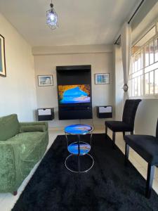 a living room with a couch and a tv at Kampala city center vin haven in Kampala