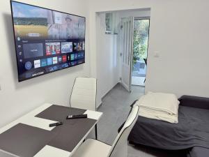 a room with a table and a bed and a tv at Sunrise Villa Lopar in Lopar