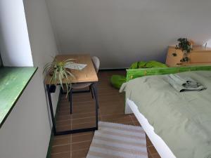 a bedroom with a desk and a bed and a table at Mackó Kuckó Verőce in Kismaros
