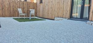 a patio with two chairs and a table next to a fence at Le Nid Charentais in Cognac +5 photos