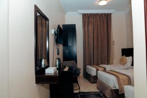 a hotel room with two beds and a mirror at كنوز العمر in Mecca