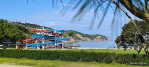a water park with a water slide next to the ocean at Apartma REA Izola, pergola & terassa, parking in Izola