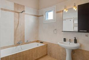 a bathroom with a sink and a bath tub and a sink at Haris House in Dhaskalión +19 photos