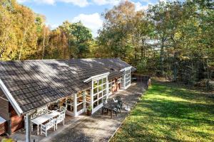 a house with a patio and a yard at 6715-Hasle-Skovkanten-12 in Hasle