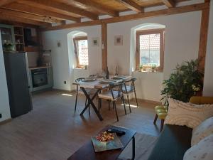 a living room with a table and a kitchen at Terra Verde in Omiš