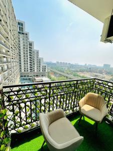 a balcony with a chair and a chair at D Haven Stays in Greater Noida