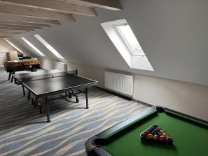 a room with a pool table in a building at Hotel Beskidian in Węgierska Górka