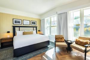 a hotel room with a bed and a chair at Calabogie Peaks Resort, an Ascend Collection Hotel in Calabogie +72 photos