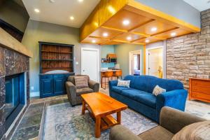 a living room with a blue couch and a fireplace at Calabogie Peaks Resort, an Ascend Collection Hotel in Calabogie