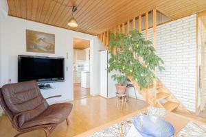 a living room with a chair and a tv at 9116-Gudhjem-Rovej-22 in Gudhjem