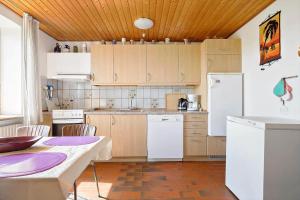a kitchen with white appliances and a wooden ceiling at 9116-Gudhjem-Rovej-22 in Gudhjem +13 photos