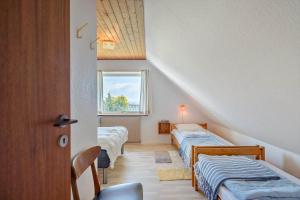 a room with three beds and a window at 9116-Gudhjem-Rovej-22 in Gudhjem