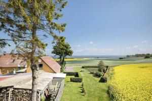 a view of a house and a field with trees at 9116-Gudhjem-Rovej-22 in Gudhjem