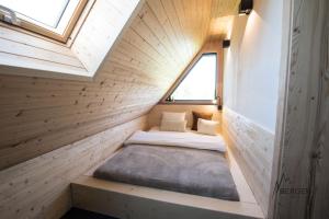 a tiny house with a bed in the middle at Chata Bergen in Vysoké Tatry
