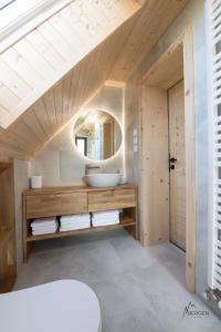 a bathroom with a sink and a mirror at Chata Bergen in Vysoké Tatry +26 photos