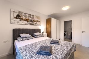 a bedroom with a bed with two towels on it at Luxurious Sea-view 3BR Apartment with Private Pool-Villa Quadris-Crikvenica in Crikvenica