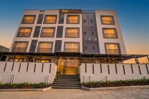 a building with a staircase in front of it at FabHotel Sahyadri Mantram in Pune