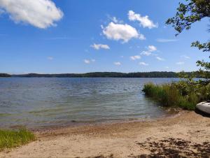 a view of a lake with a sandy shore at Biskopsdal in Karuna