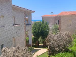 an external view of a building with trees in front at Diana Beach Villa spacious detached فيلا واسعه مستقله ديانا ONLY FAMILIES بيتش in Dawwār al Ḩajj Aḩmad