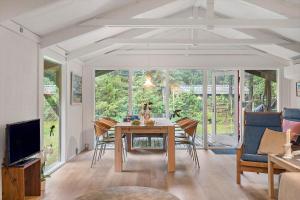a dining room with a table and chairs at JB353-Brovst-Hjortevaenget-13 in Brovst