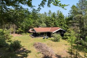 a small house in the middle of a field at JB353-Brovst-Hjortevaenget-13 in Brovst +13 photos