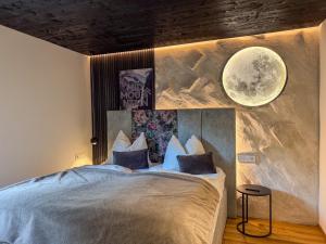 a bedroom with a large bed with a moon mural at Mid Mountain Apartment Tirol in Wiesing